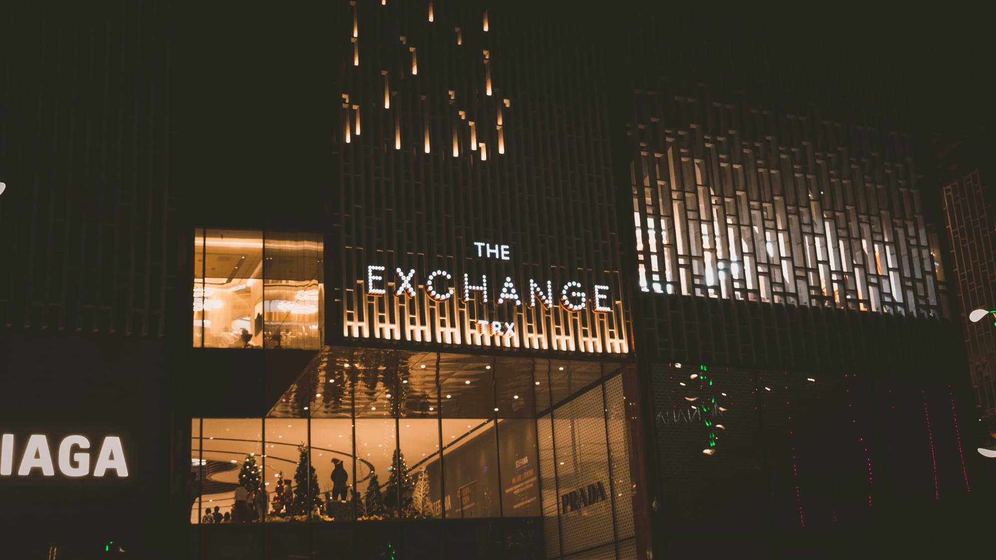 The lit entrance of The Exchange TRX in Kuala Lumpur at night